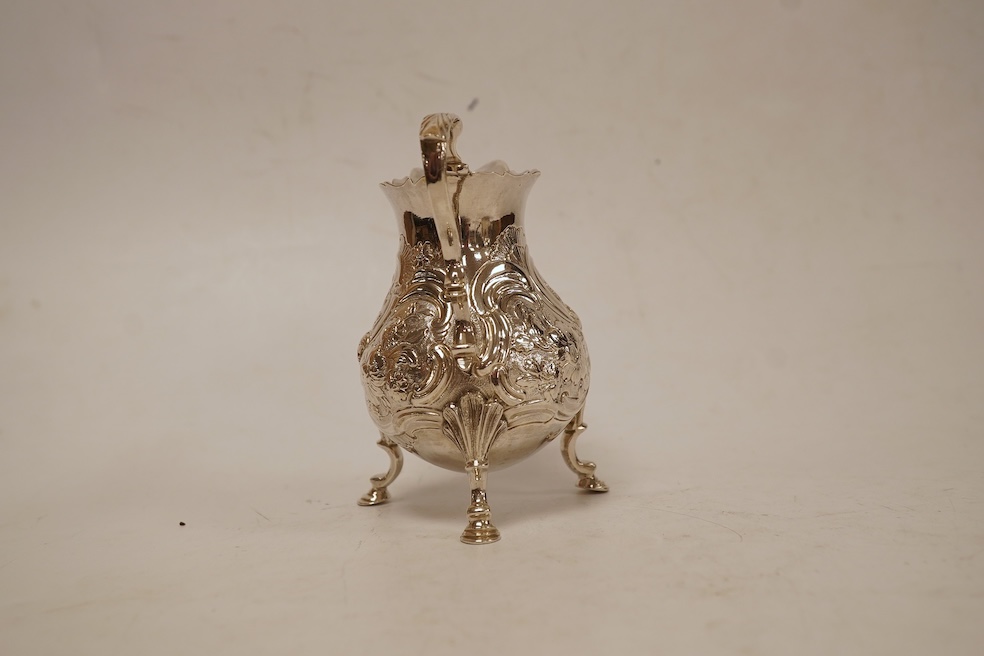 A late George II silver baluster cream jug, with later embossed decoration, on three hoof feet, Samuel Meriton I London, 1756, 10.6cm, 3.3oz.